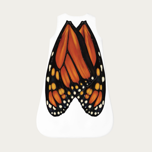 Flat lay of baby sleep sack showing monarch butterfly wings printed naturally across the back on a white fabric body.
