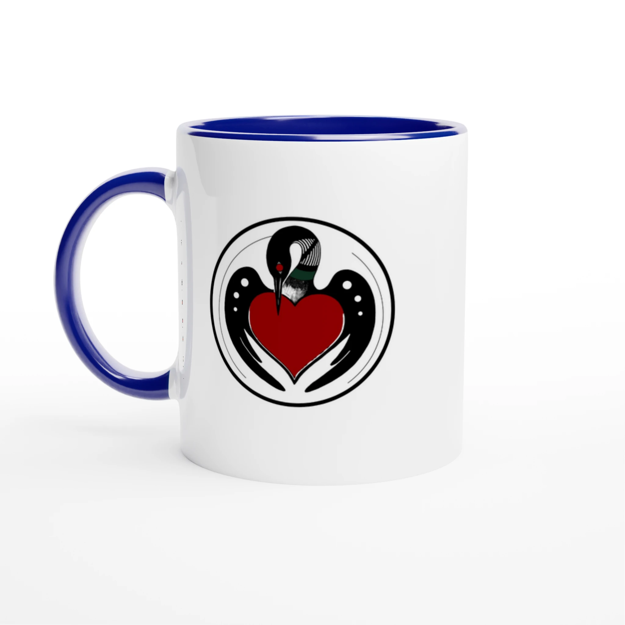 Ceramic mug with a clean, artist‑illustrated BWCA loon emblem and text, glossy finish, and blue colored rim and handle, set to the left.