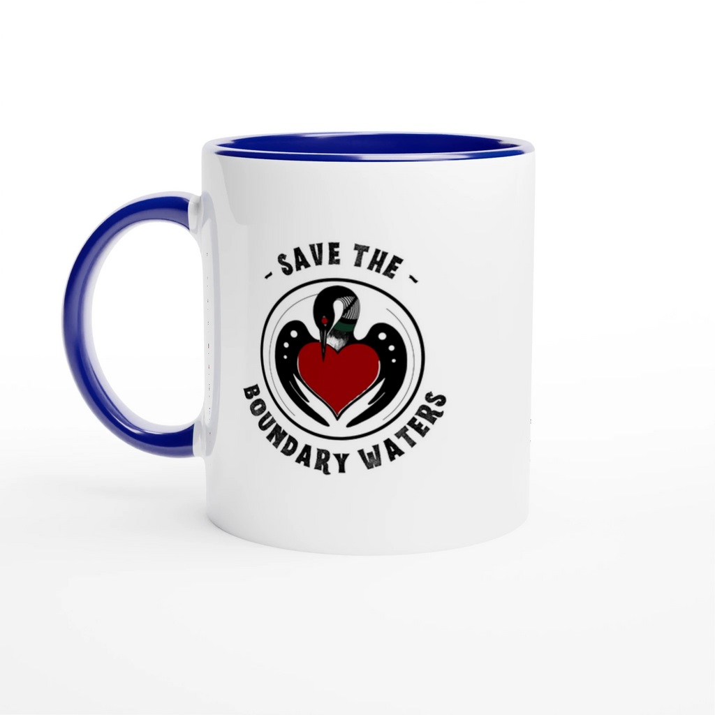 White ceramic mug with circular loon artwork, blue colored rim and handle, set to the left.
