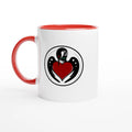 Ceramic mug featuring Holly Ulm’s clean loon illustration inspired by Minnesota lake country, red colored rim and handle, set to the left.