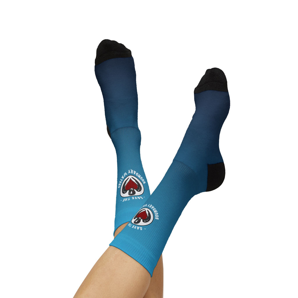 Minnesota state flag blue crew socks with rebel loon logo on model with feet up legs crossed