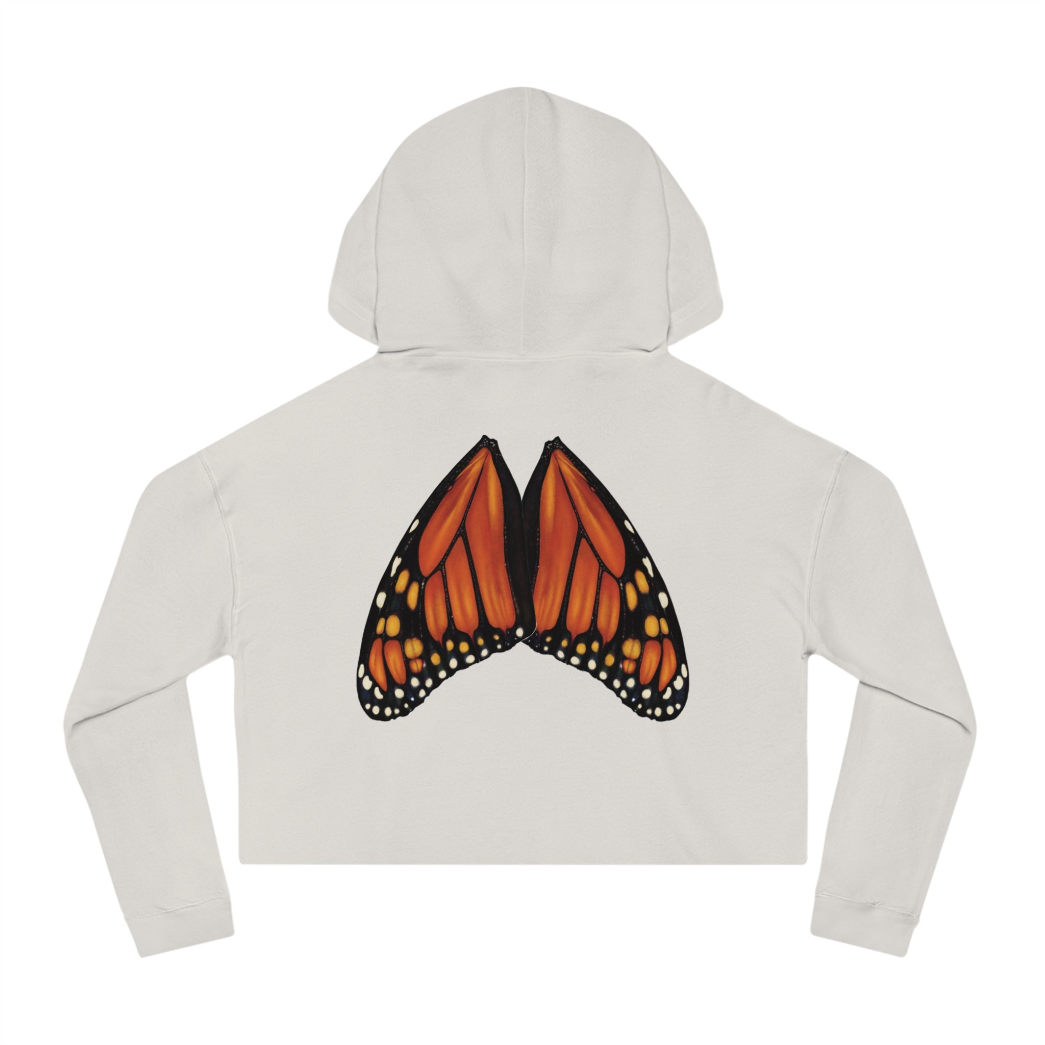 Flat lay of bone‑colored cropped hoodie with high‑detail monarch wings positioned naturally on the back.