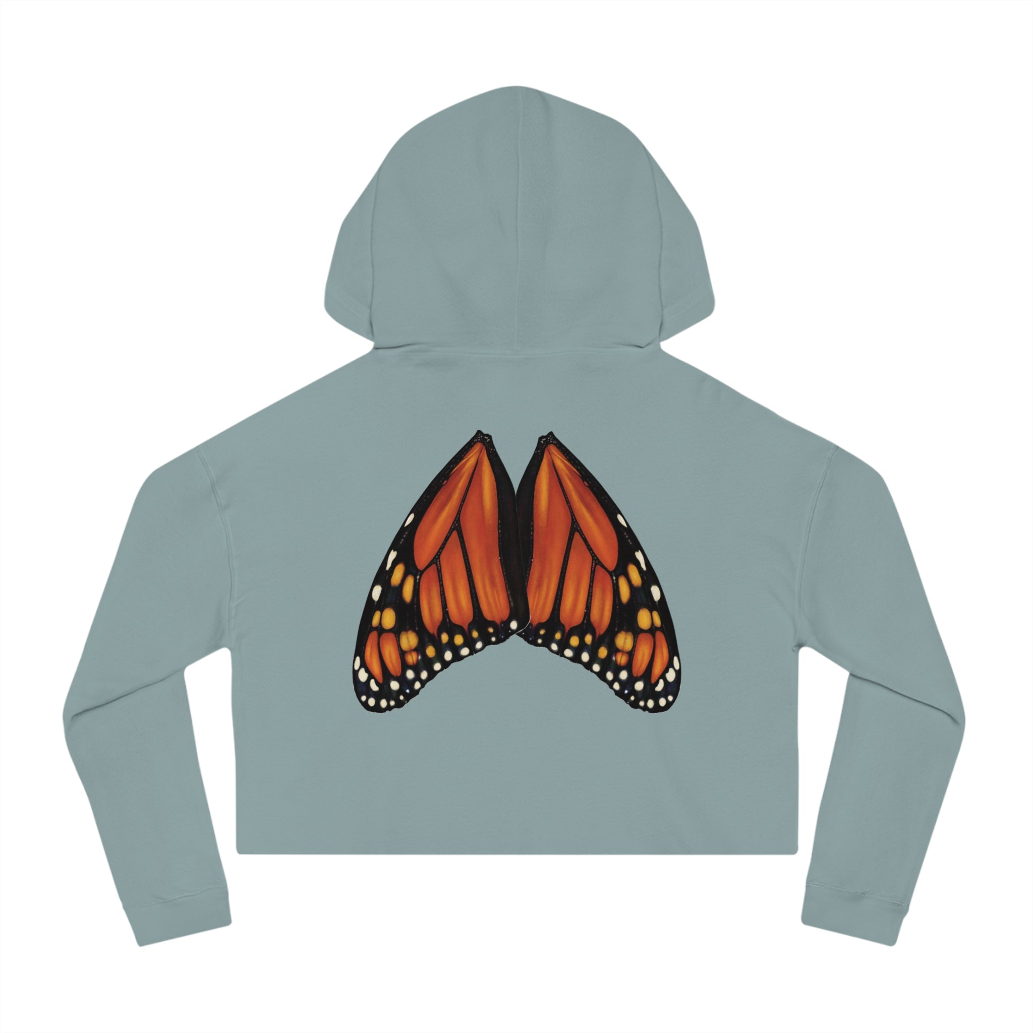 Flat lay of sage green cropped hoodie with detailed monarch wings placed in natural wing formation on the back.