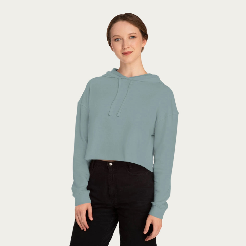 Model wearing sage cropped hoodie, front view, showing hood, drawstrings, and soft pastel color.