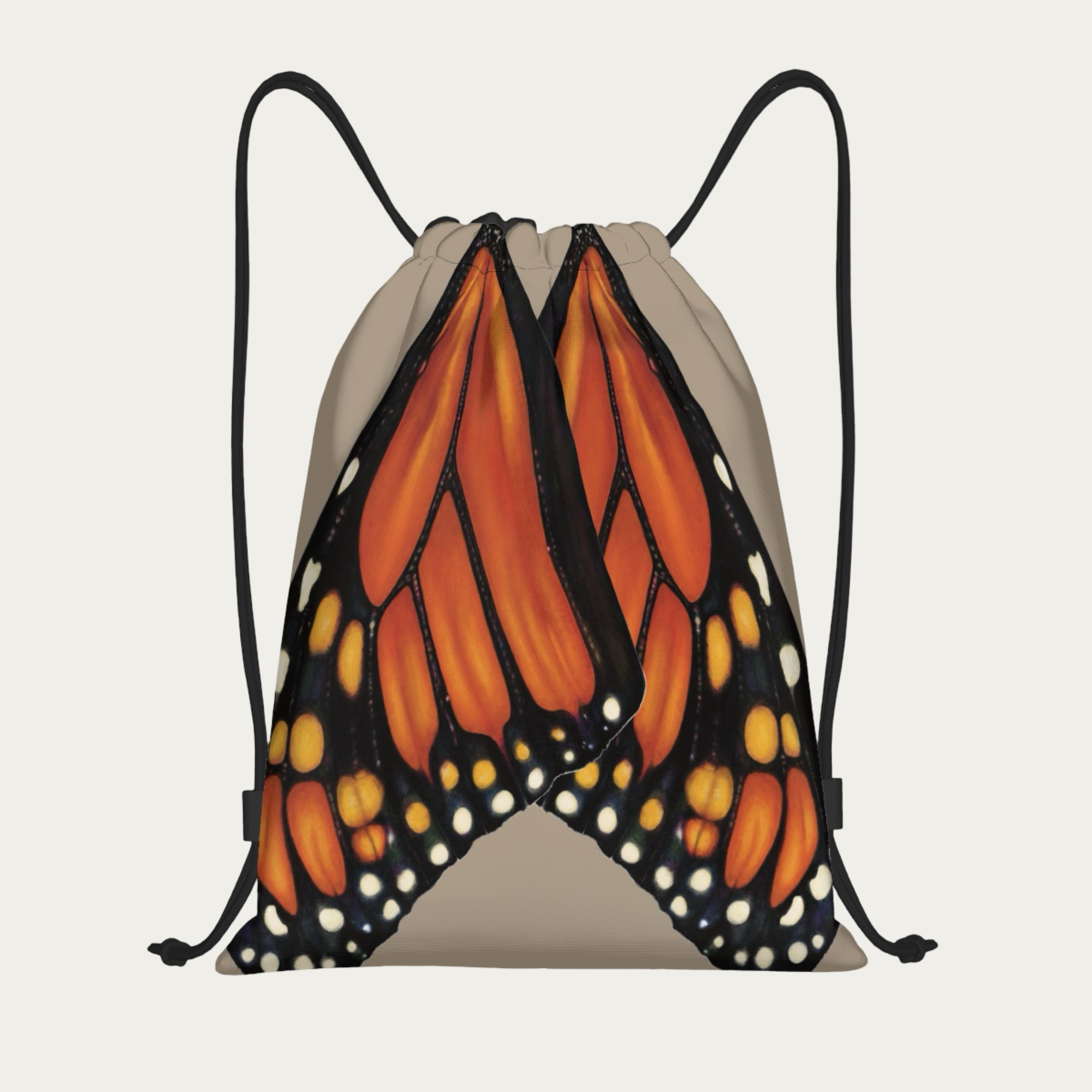 Floating view of sand drawstring backpack with monarch butterfly wings printed in natural alignment across the back.