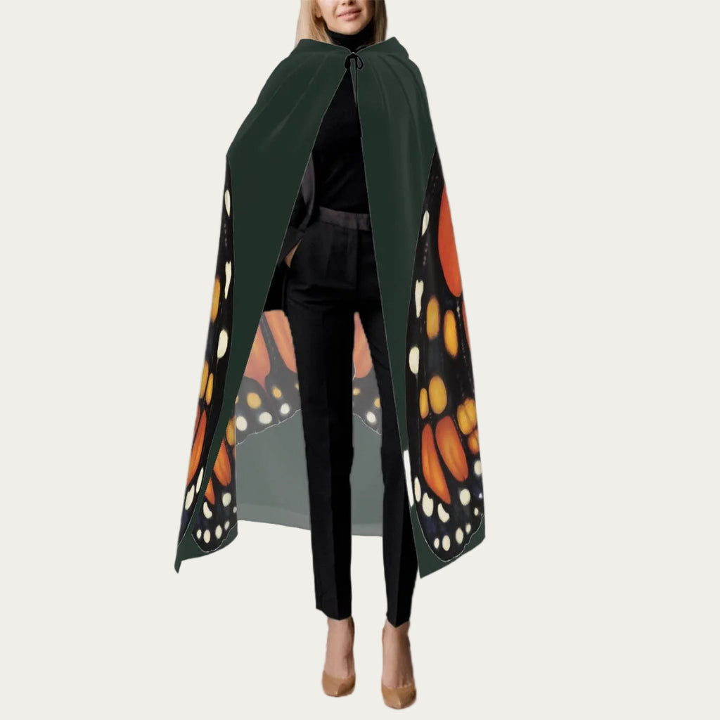 Front view of model wearing hunter green hooded floor‑length cape with tie closure at the neck and smooth front drape.