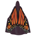 Model standing with back facing camera wearing plum hooded cape showing monarch butterfly wings spread wide across the back.