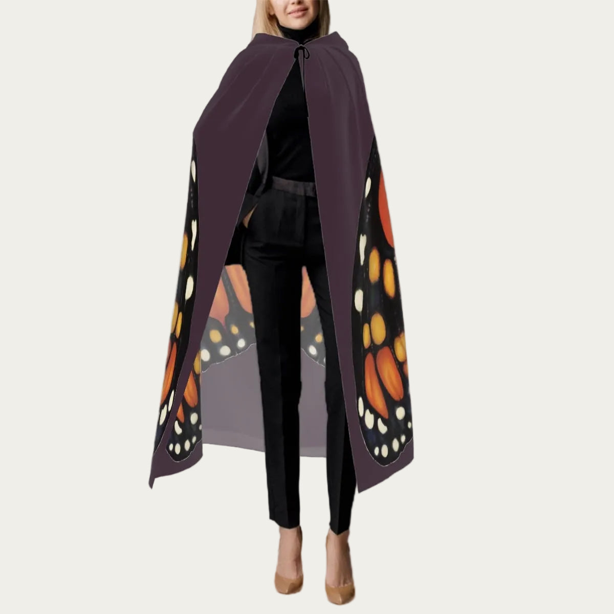 Front view of model wearing plum hooded floor‑length cape with tie closure at the neck and smooth front drape.