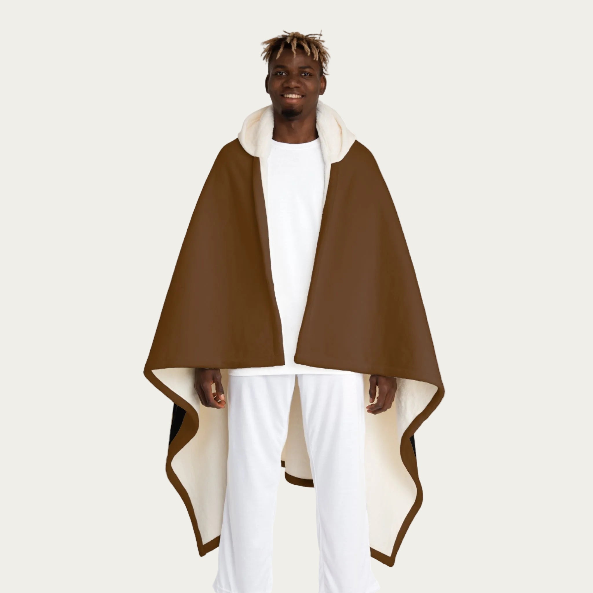 Front view of model wearing brown hooded sherpa blanket hanging straight down like a cape, showing cream sherpa‑lined hood and smooth front panel.
