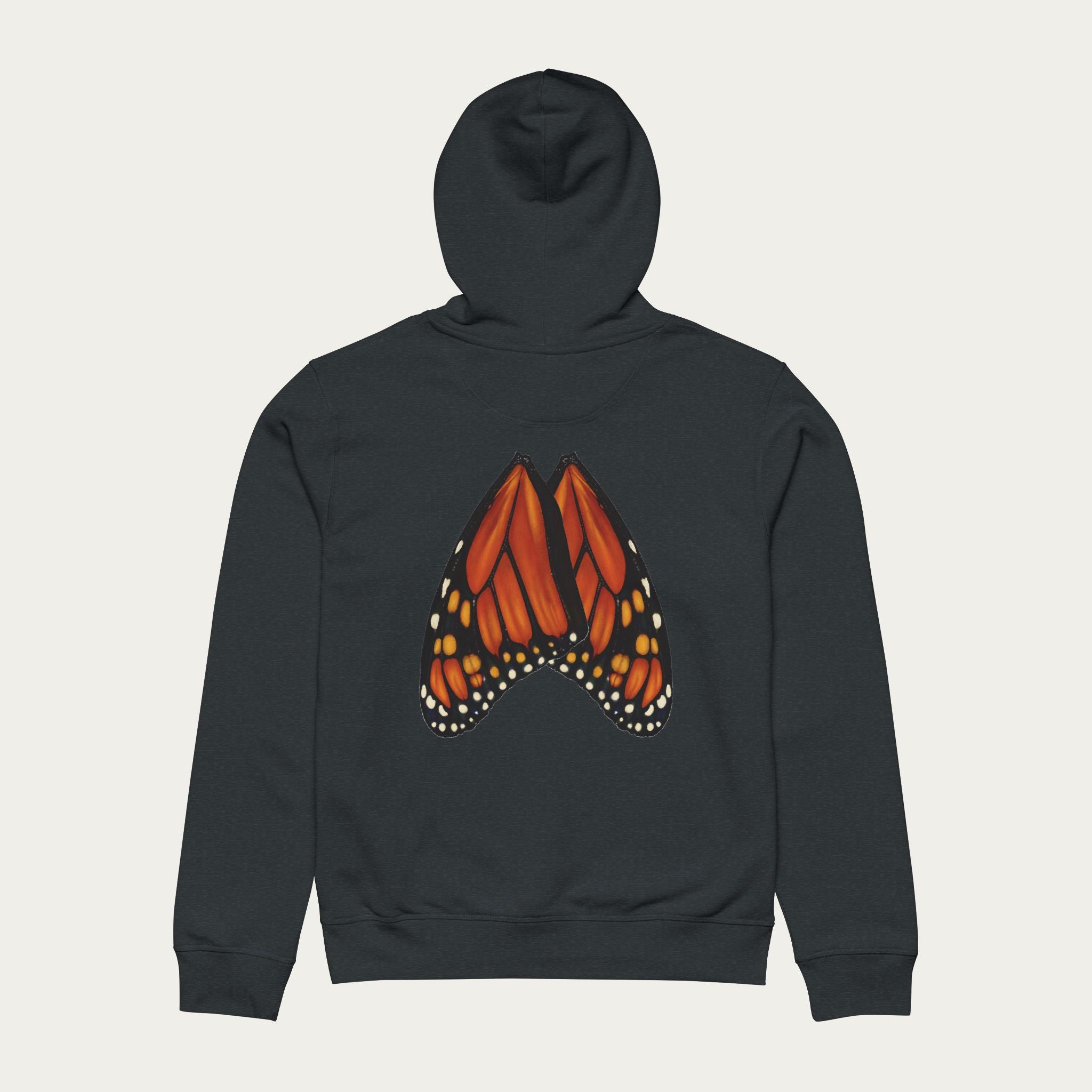 Flat lay of dark heather grey hoodie featuring detailed monarch butterfly wing artwork across the back panel.