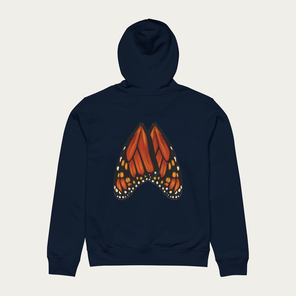 Flat lay of french navy hoodie displaying monarch wing illustration positioned naturally across the back.

