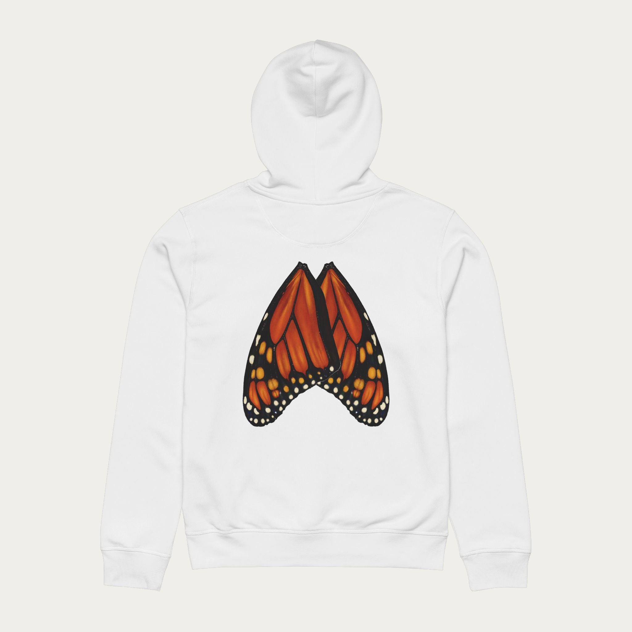 Flat lay of white unisex hoodie showing full‑scale monarch butterfly wings printed naturally across the back.