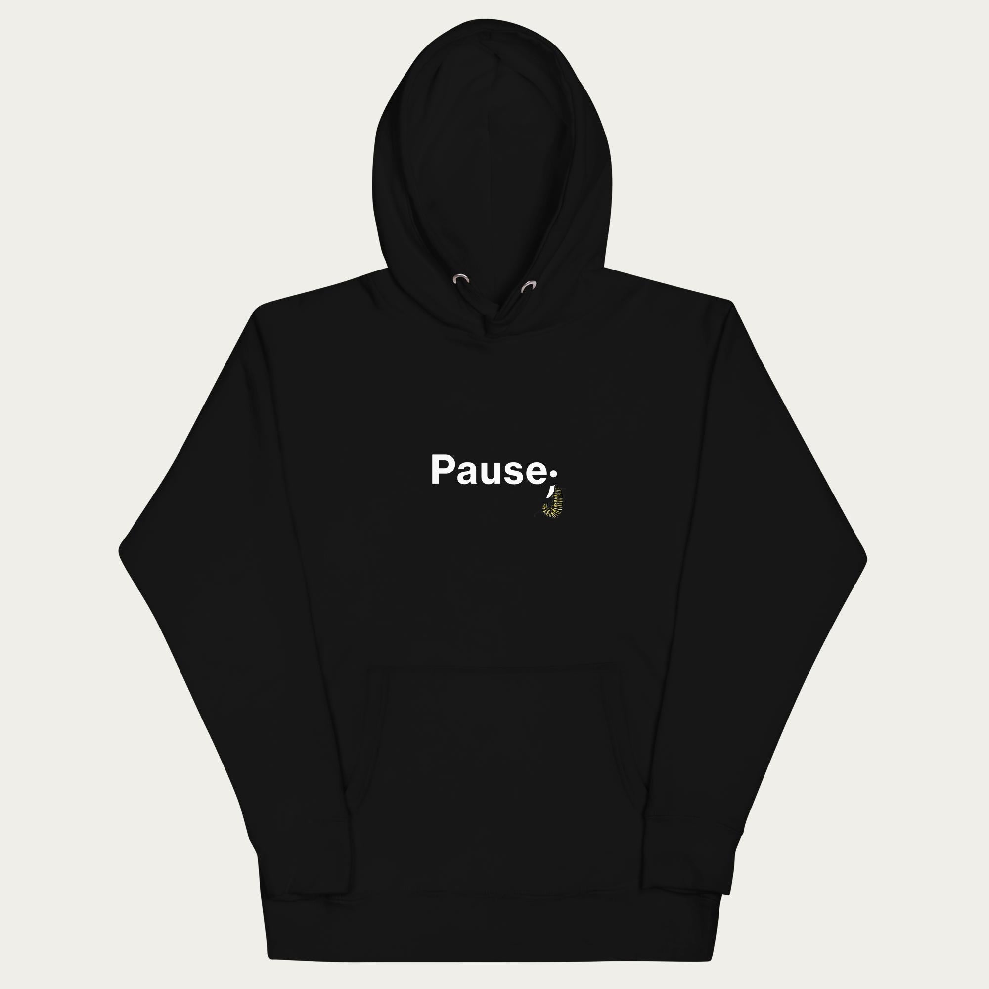 Front flat lay of black unisex hoodie showing “Pause;” text with monarch caterpillar curled into a semicolon on the chest, hood and drawstrings visible.