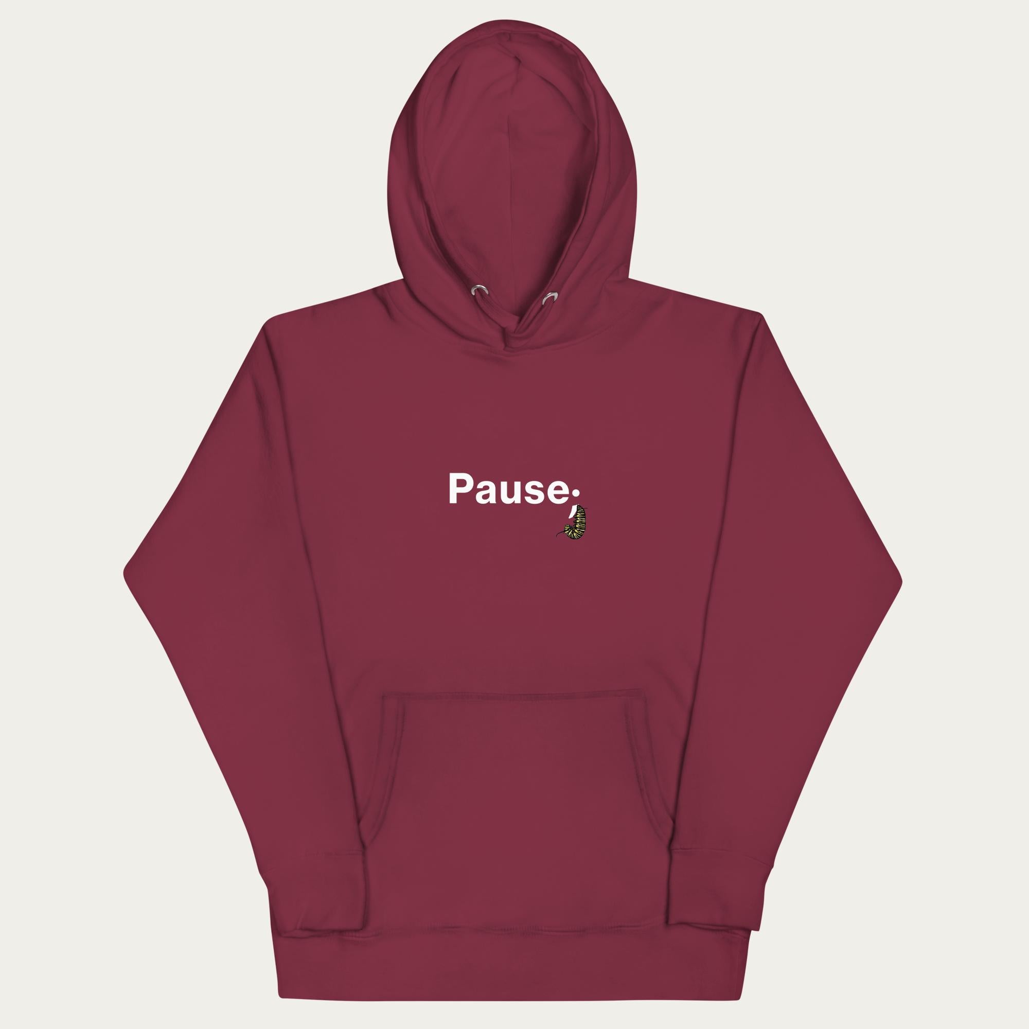 Front flat lay of maroon unisex hoodie showing monarch caterpillar shaped into a semicolon within the “Pause;” design on the chest.