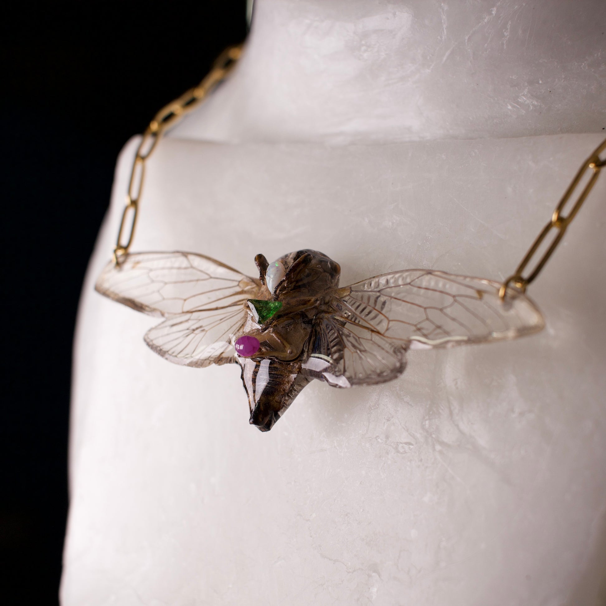Real cicada necklace Do Day Cicadas gold paperclip chain opal emerald ruby close up on wax form