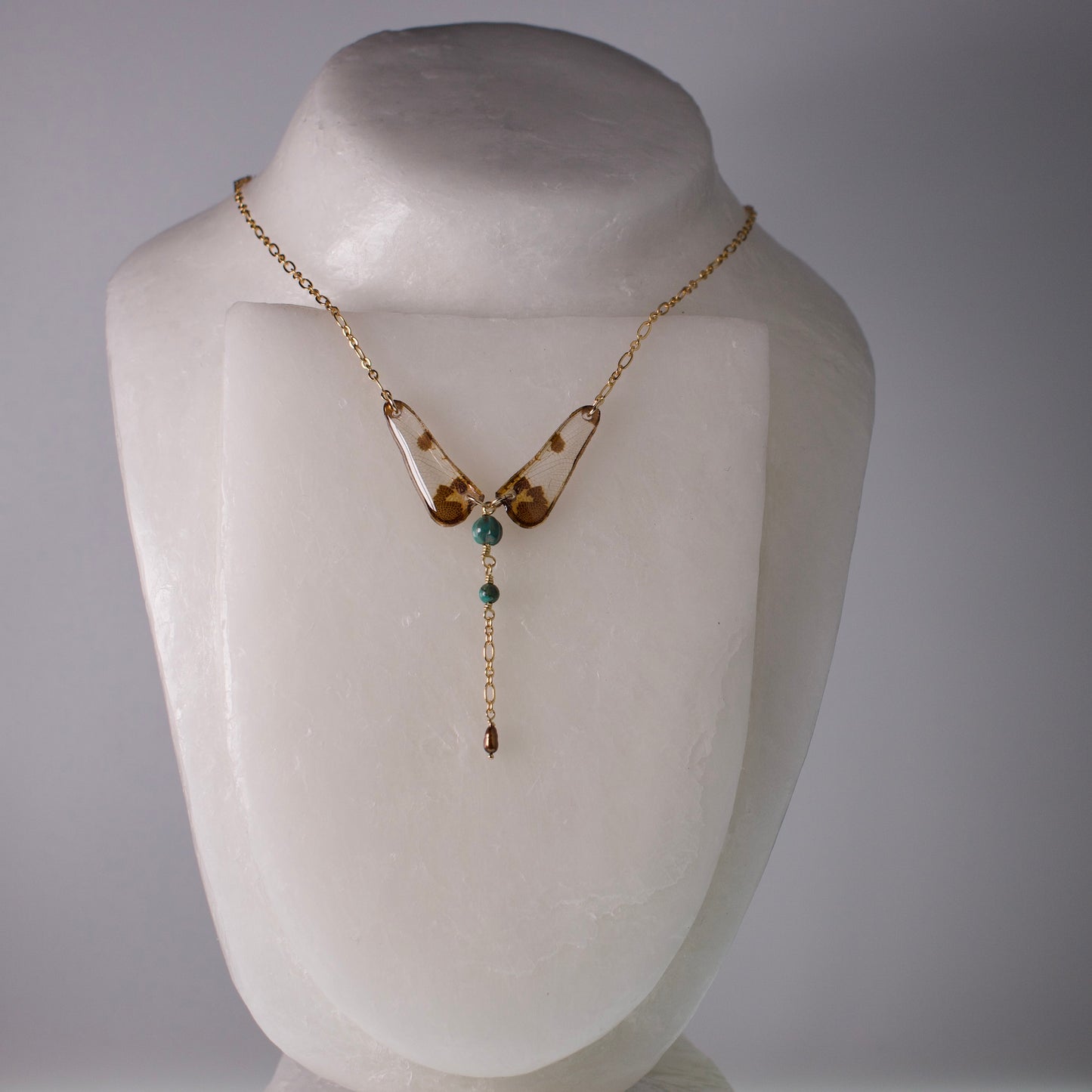 dragonfly necklace turquoise pearl gold chain on white mannequin
