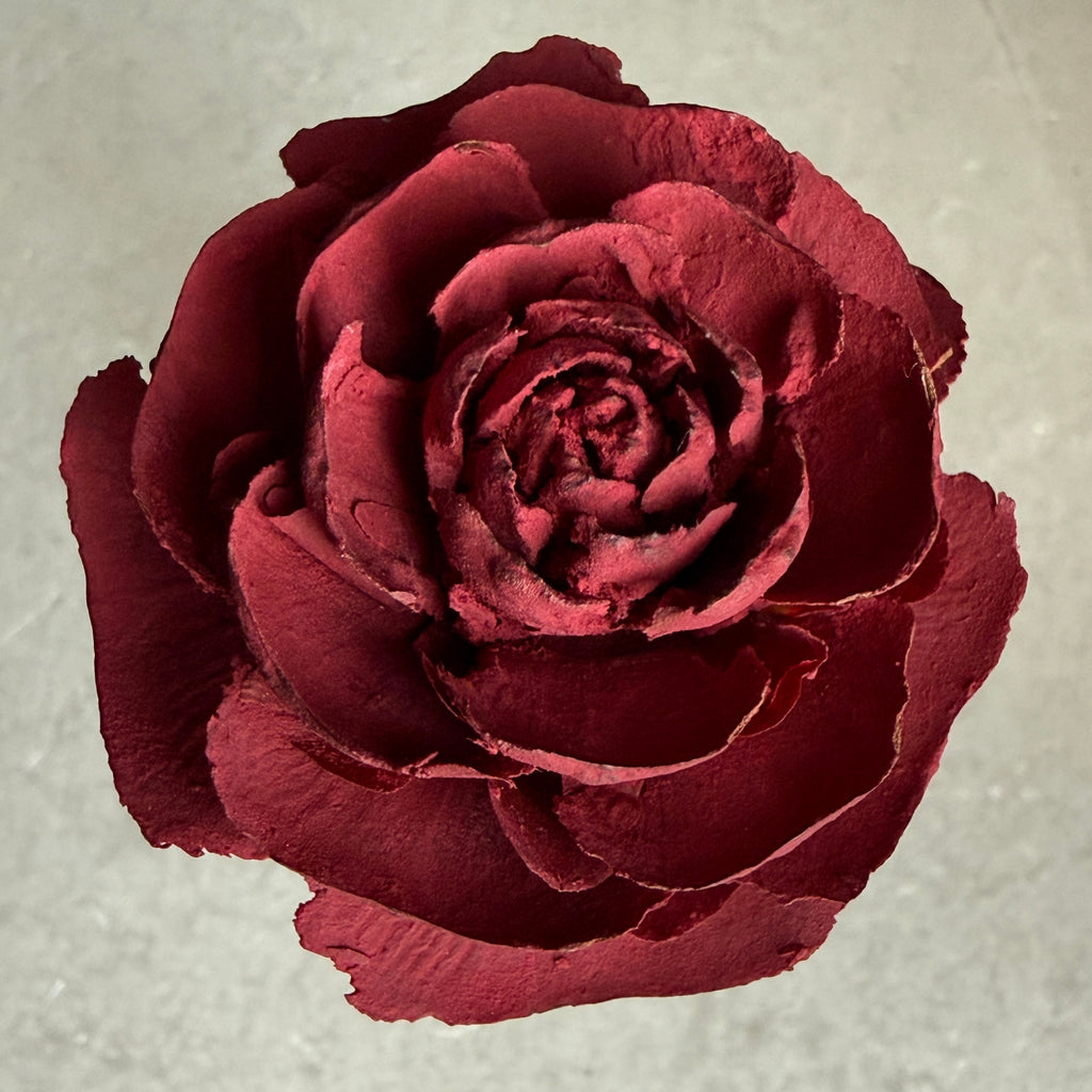 Top view of a deep burgundy Cedar Rose showing the naturally rosette shaped real wood cone form.