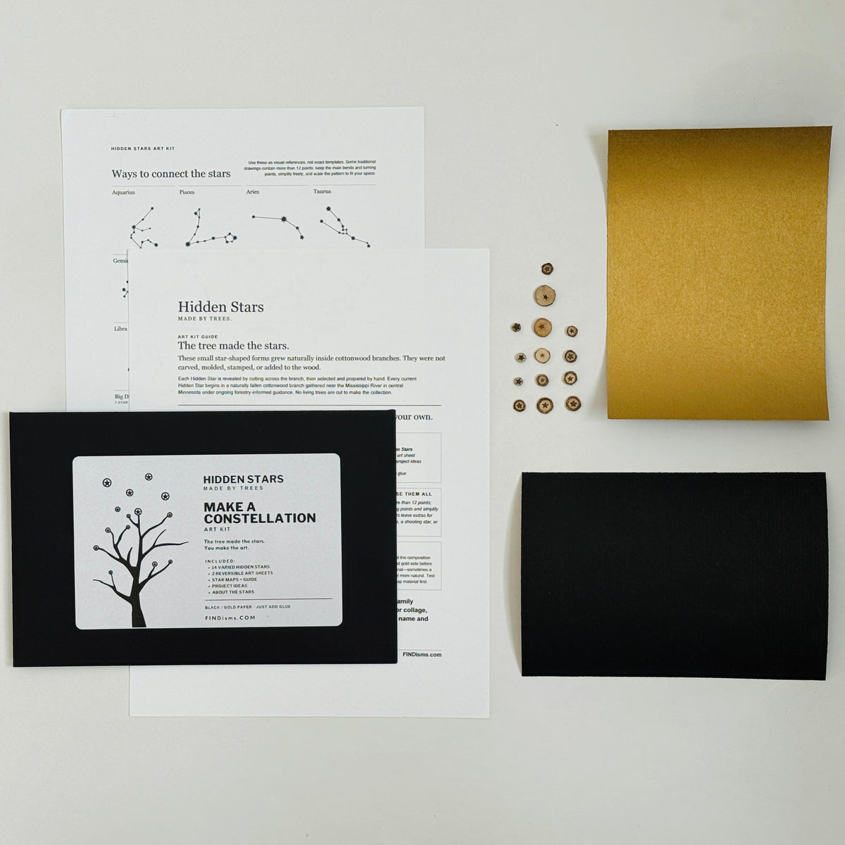 Hidden Stars Make a Constellation Art Kit with 14 cottonwood stars, black and gold art paper, guide, constellation references, and black envelope