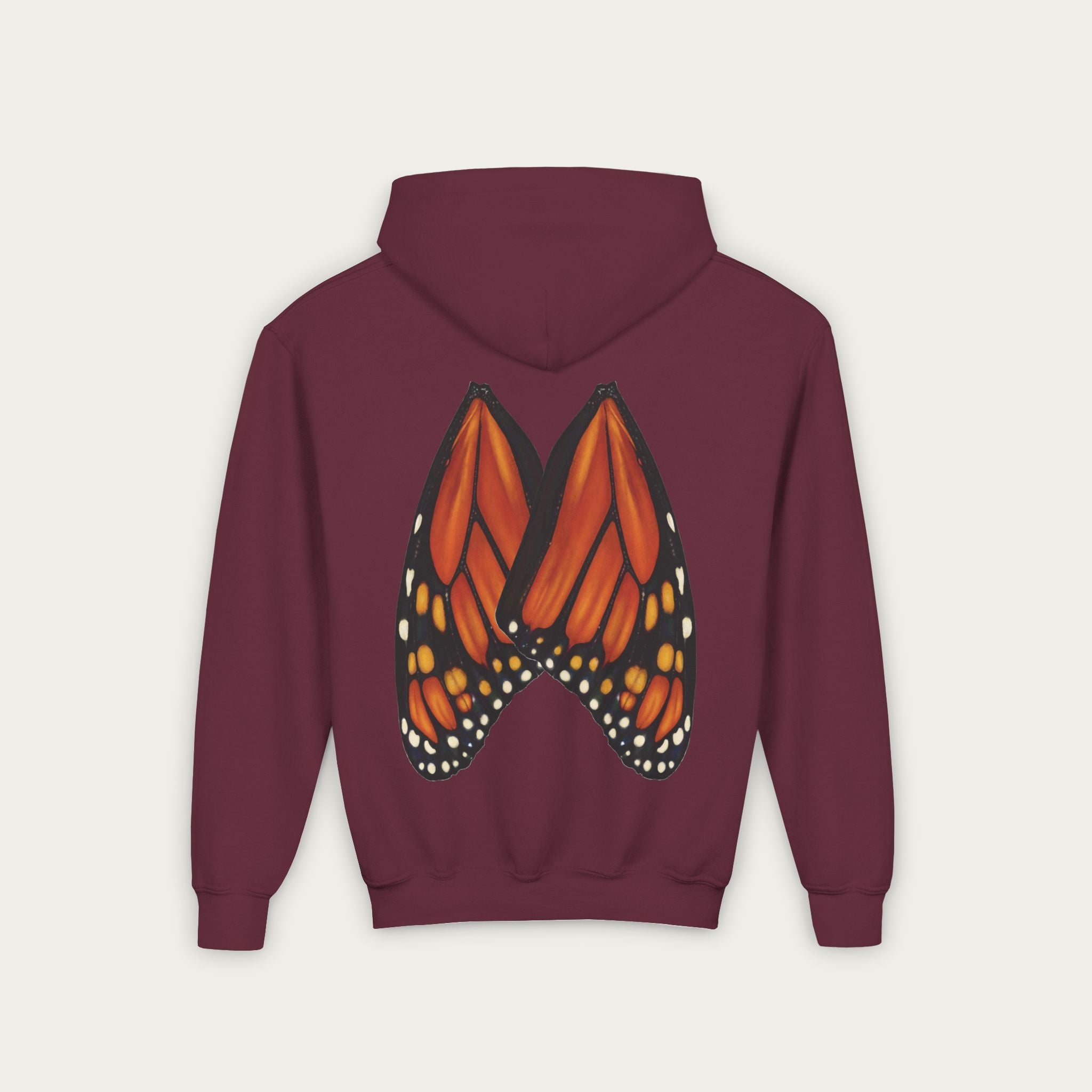 Burgundy kids hoodie with mn artist illustrated monarch butterfly wings on back flat lay view white background