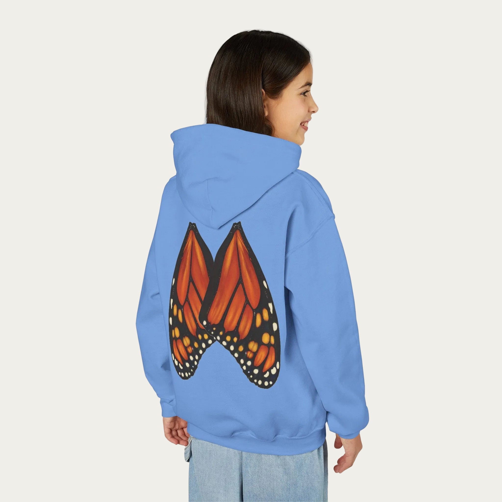 Carolina blue kids hoodie with Minnesota artist illustrated monarch butterfly wings on back girl model white background