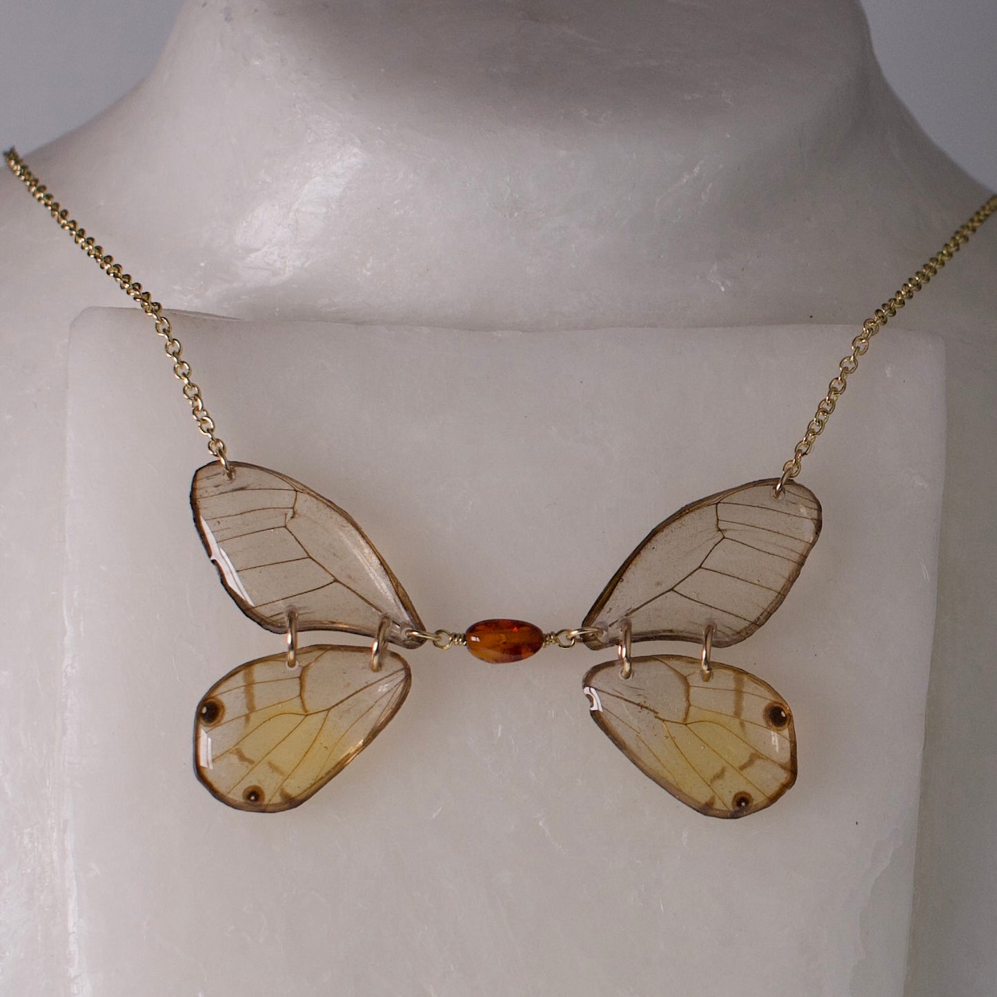 real butterfly wing necklace phantom butterflies gold chain amber beadwork on wax neck form