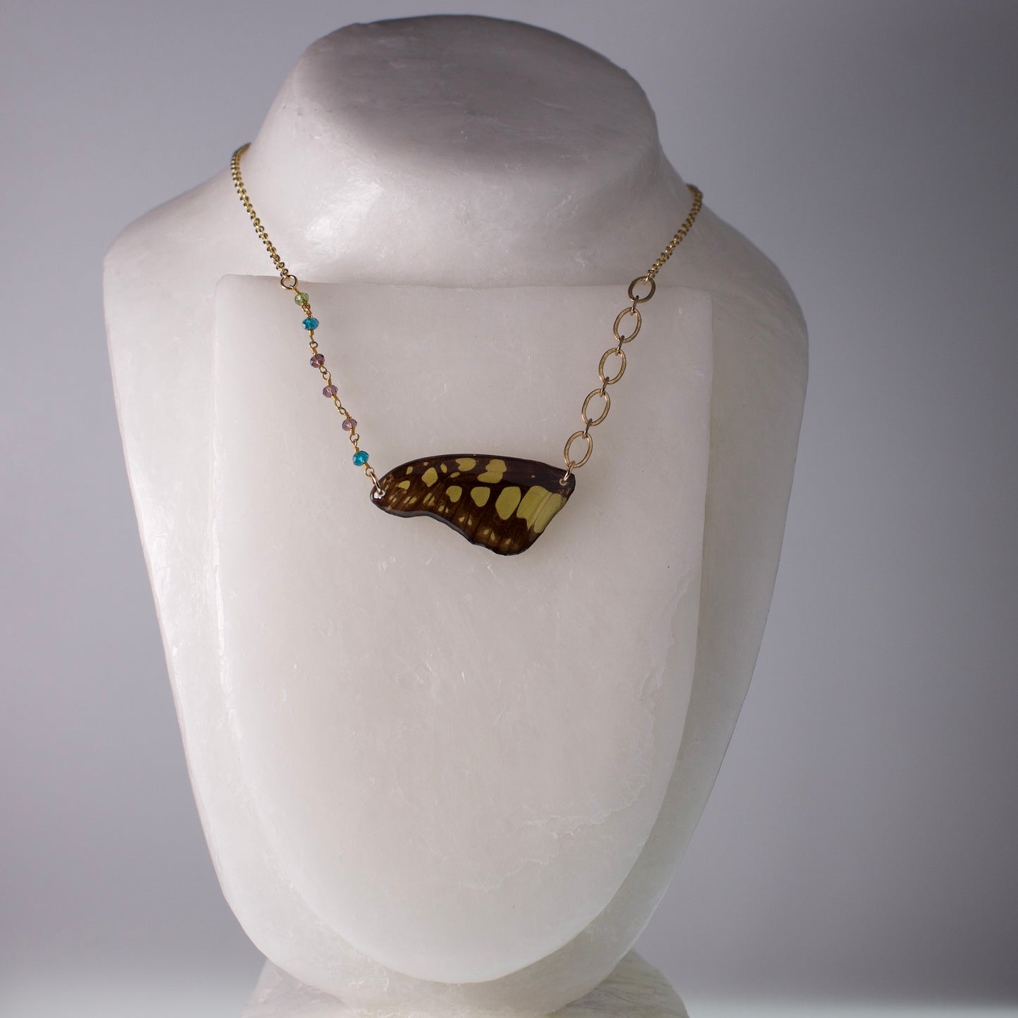 real butterfly wing necklace electric green swordtail butterflies gold asymmetric multi-color beads on mannequin