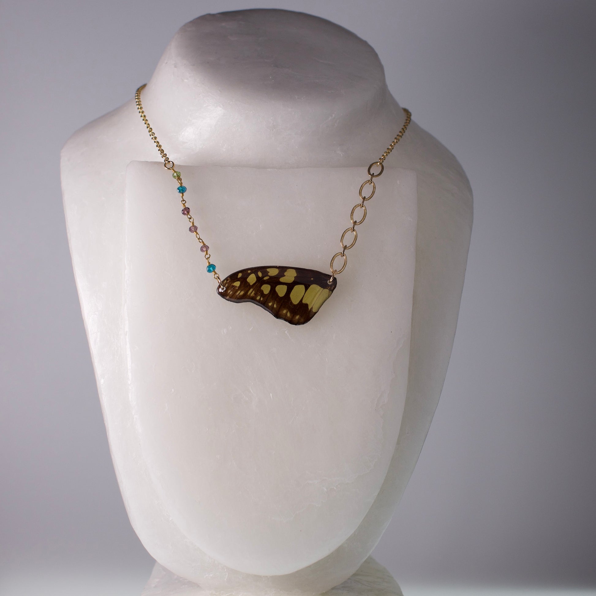 real butterfly wing necklace electric green swordtail butterflies gold asymmetric multi-color beads on mannequin