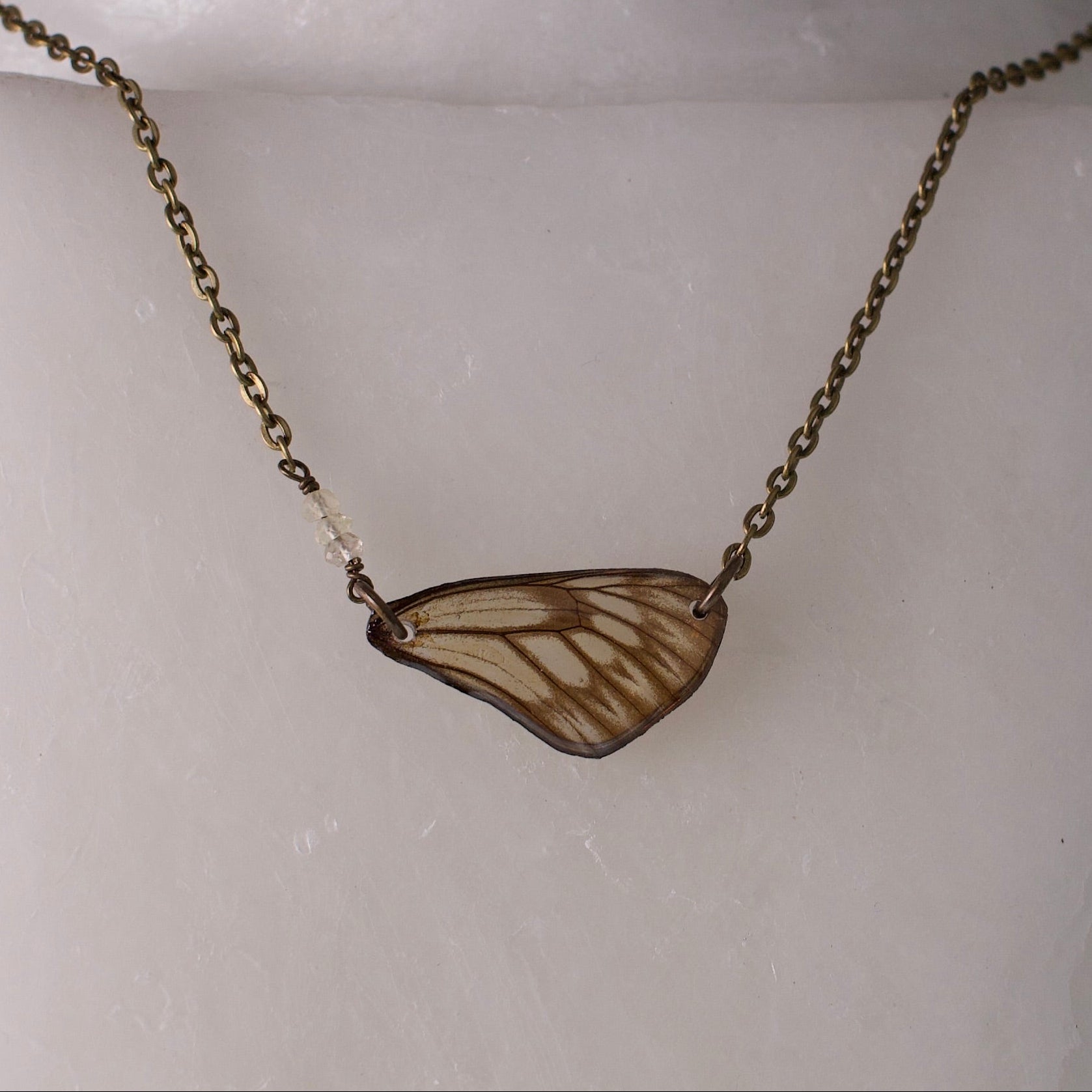 real butterfly wing necklace striped green khaki butterflies yellow citrine bronze necklace close up on wax