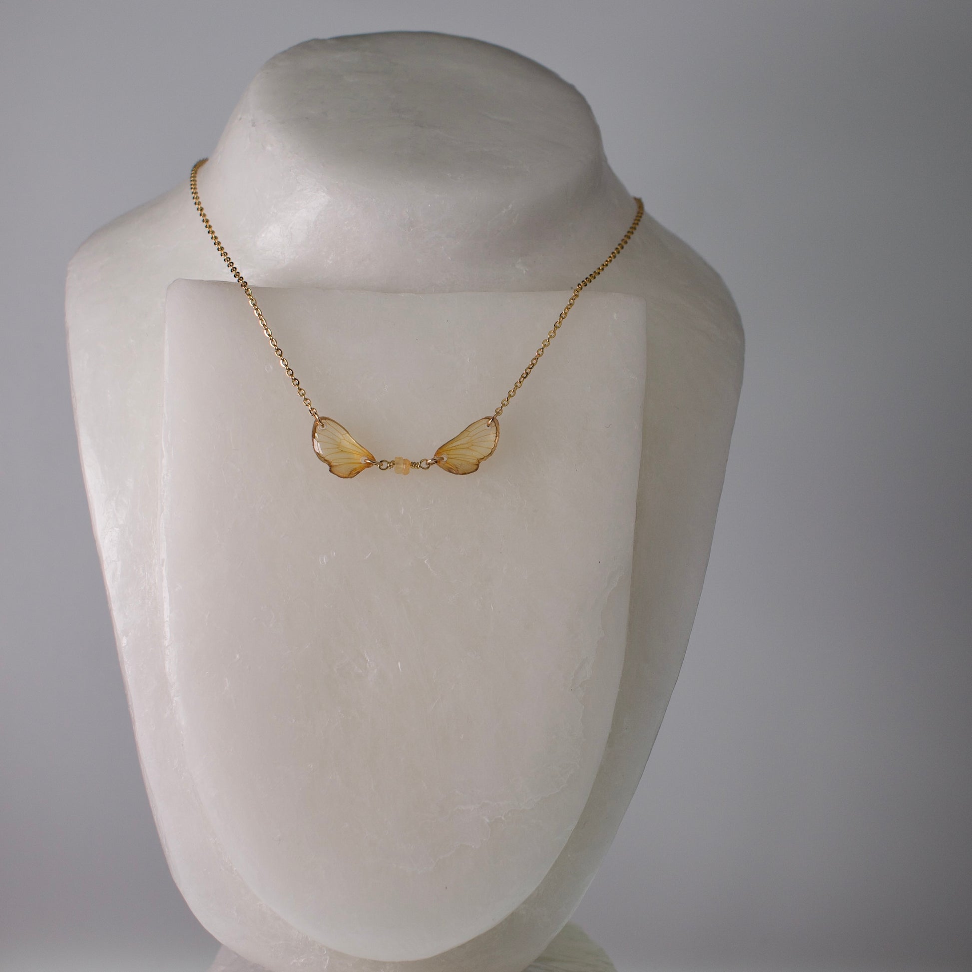 real cicada wing necklace tiny gold cicadas sapphire gold chain on mannequin
