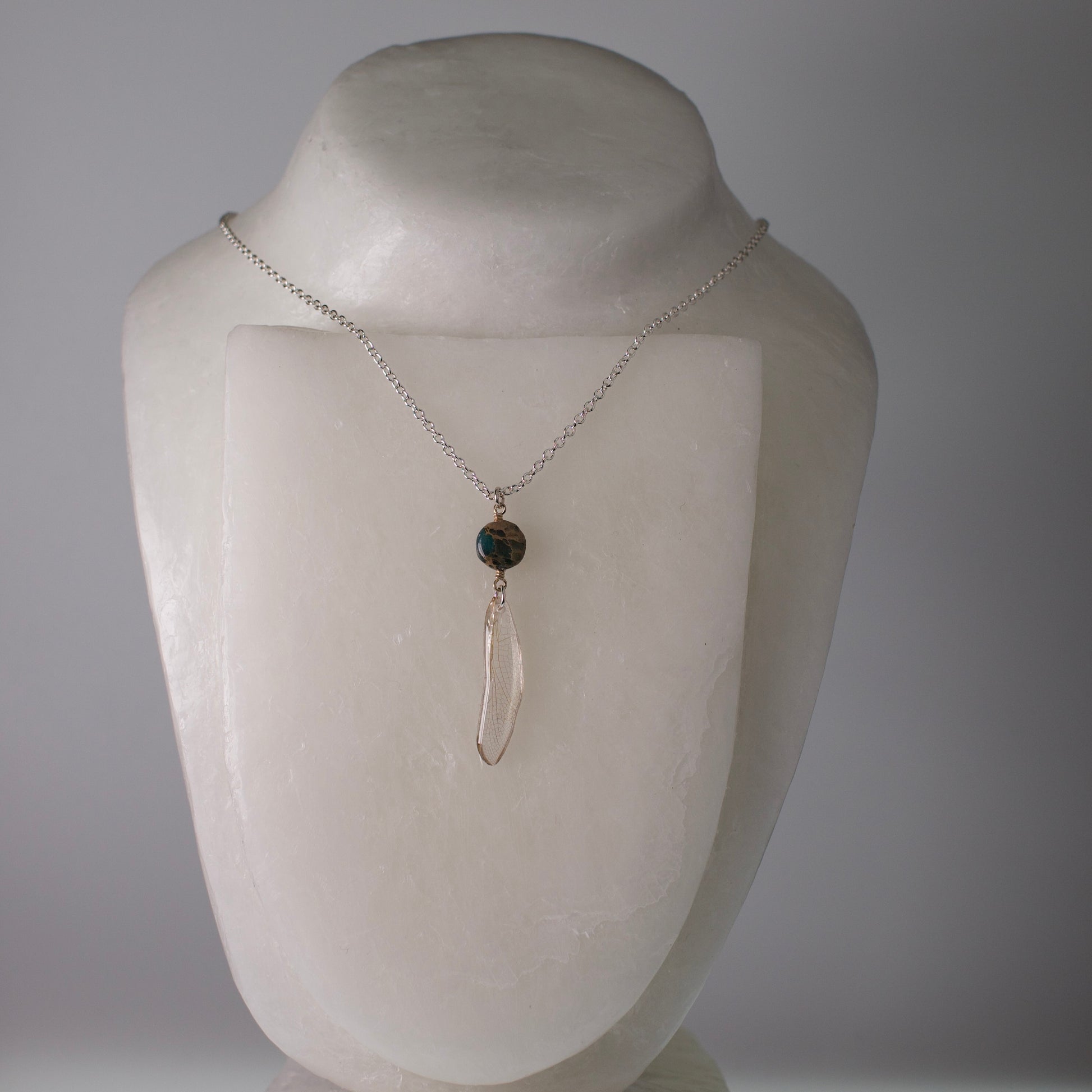real dragonfly pendant silver necklace ocean jasper bead on wax form grey background