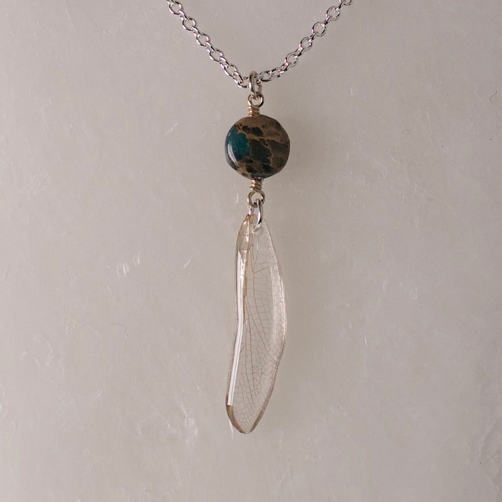 real dragonfly wing pendant silver necklace ocean jasper wax background