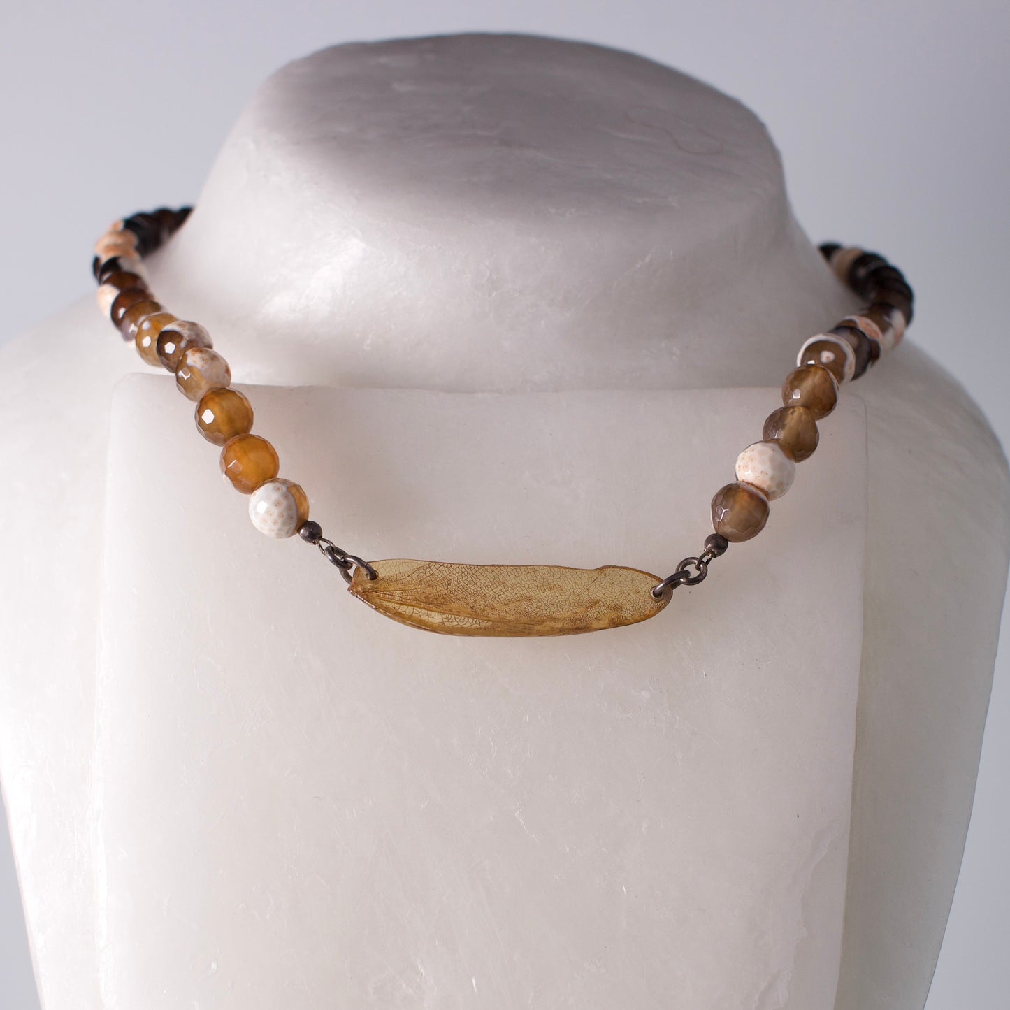 real praying mantis wing pendant sterling silver faceted agate strand necklace on mannequin